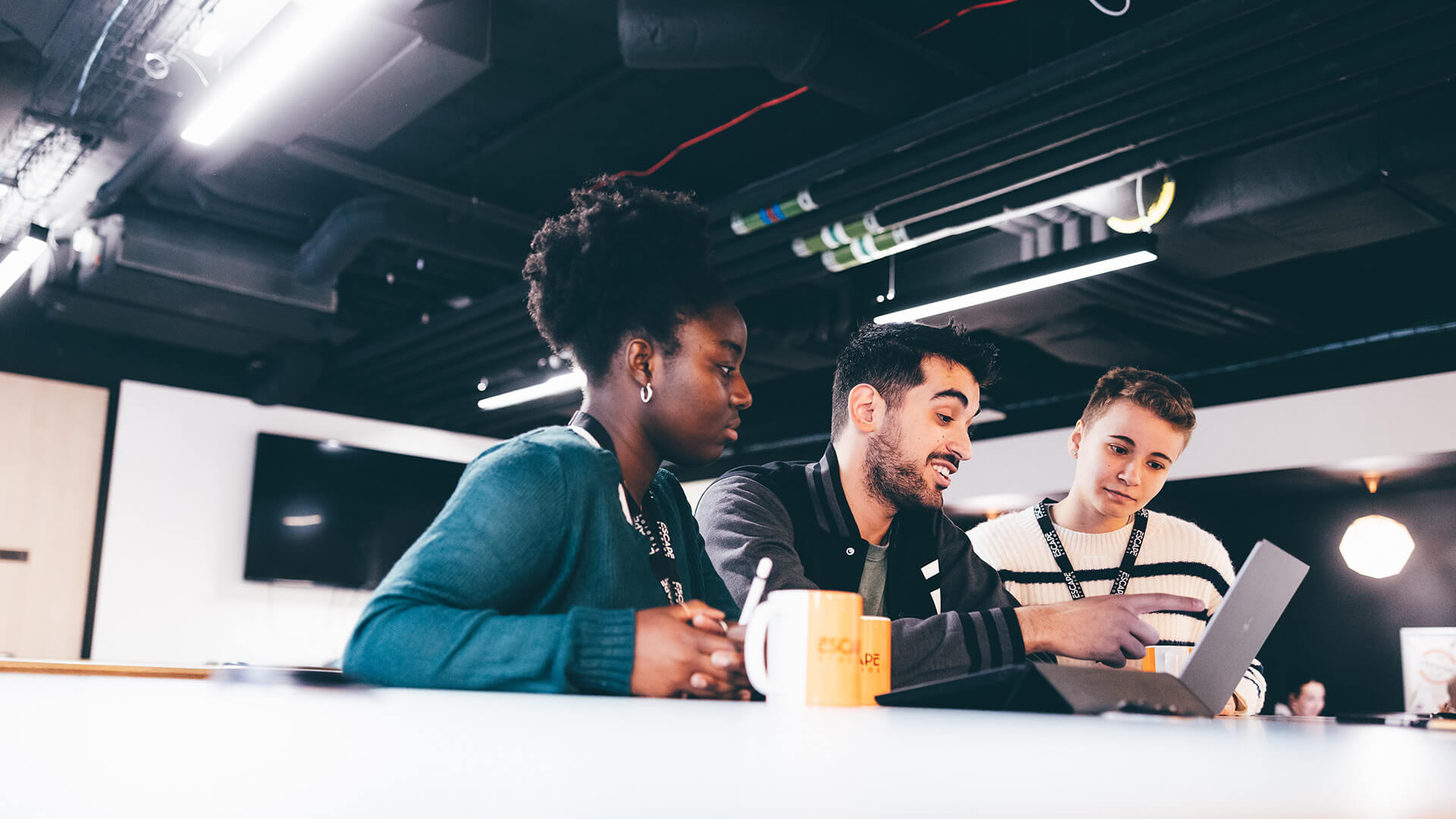 Three students working on laptop