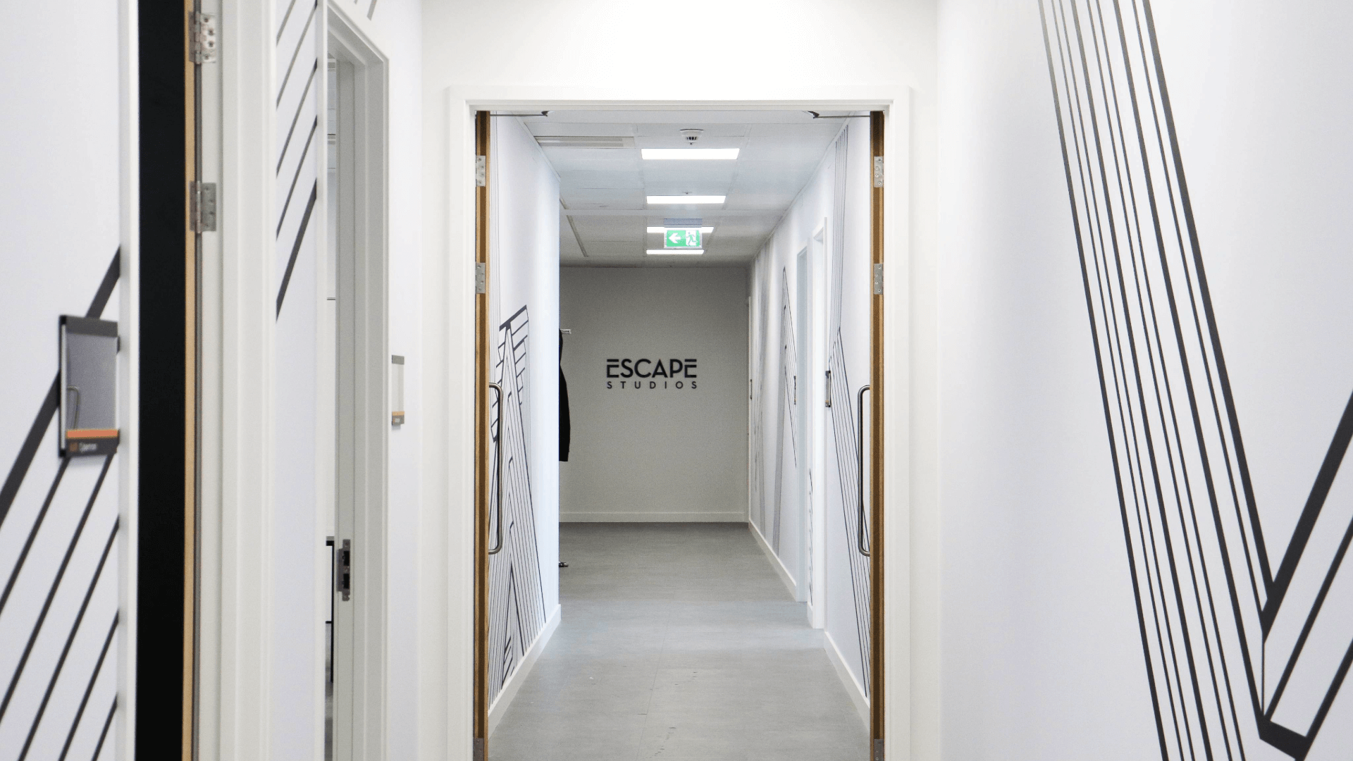 Escape Studios corridor with logo sign on the wall in the background