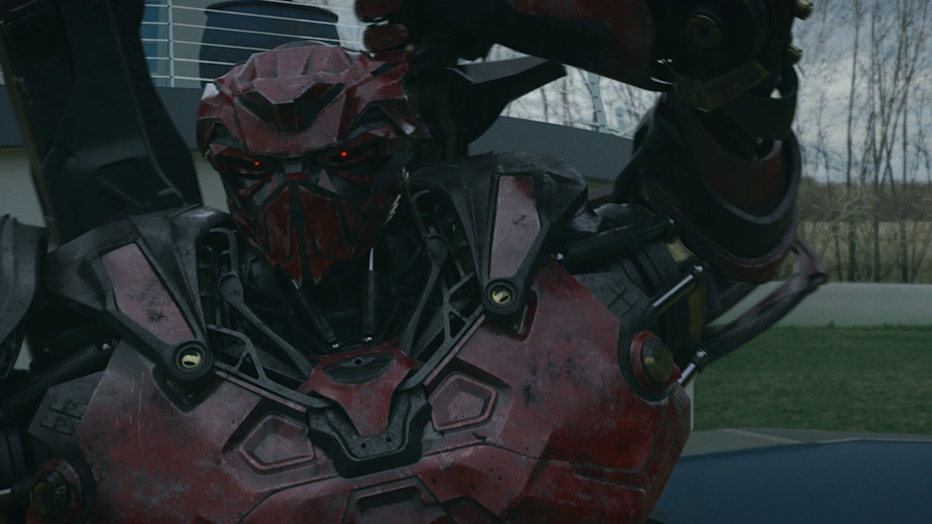 A red animated robot stood outside a white house